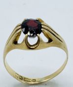 9ct gold ring set with a single red stone