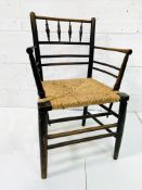 A late Victorian Morris & Co. ‘Sussex’ chair oak framed rail back open arm chair.