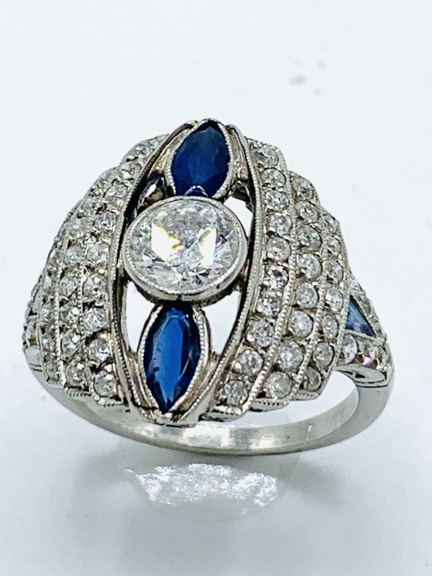 Art Deco white gold diamond and sapphire ring. Size O 1/2 Wt. 7.8gms. Size of centre diamond 6.3m