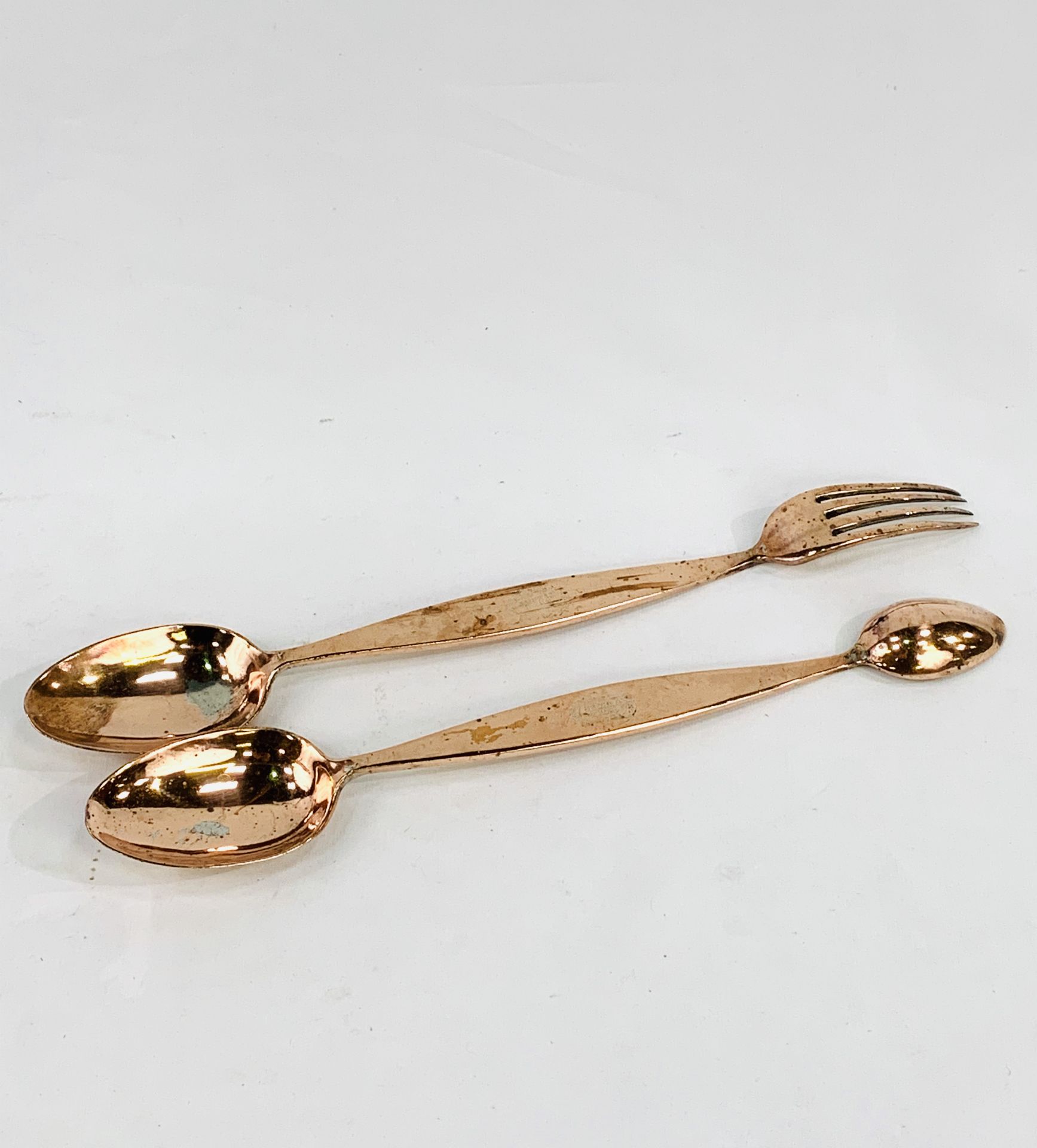 Two copper Benham and Son's serving utensils, marked with a crown and initals RY.