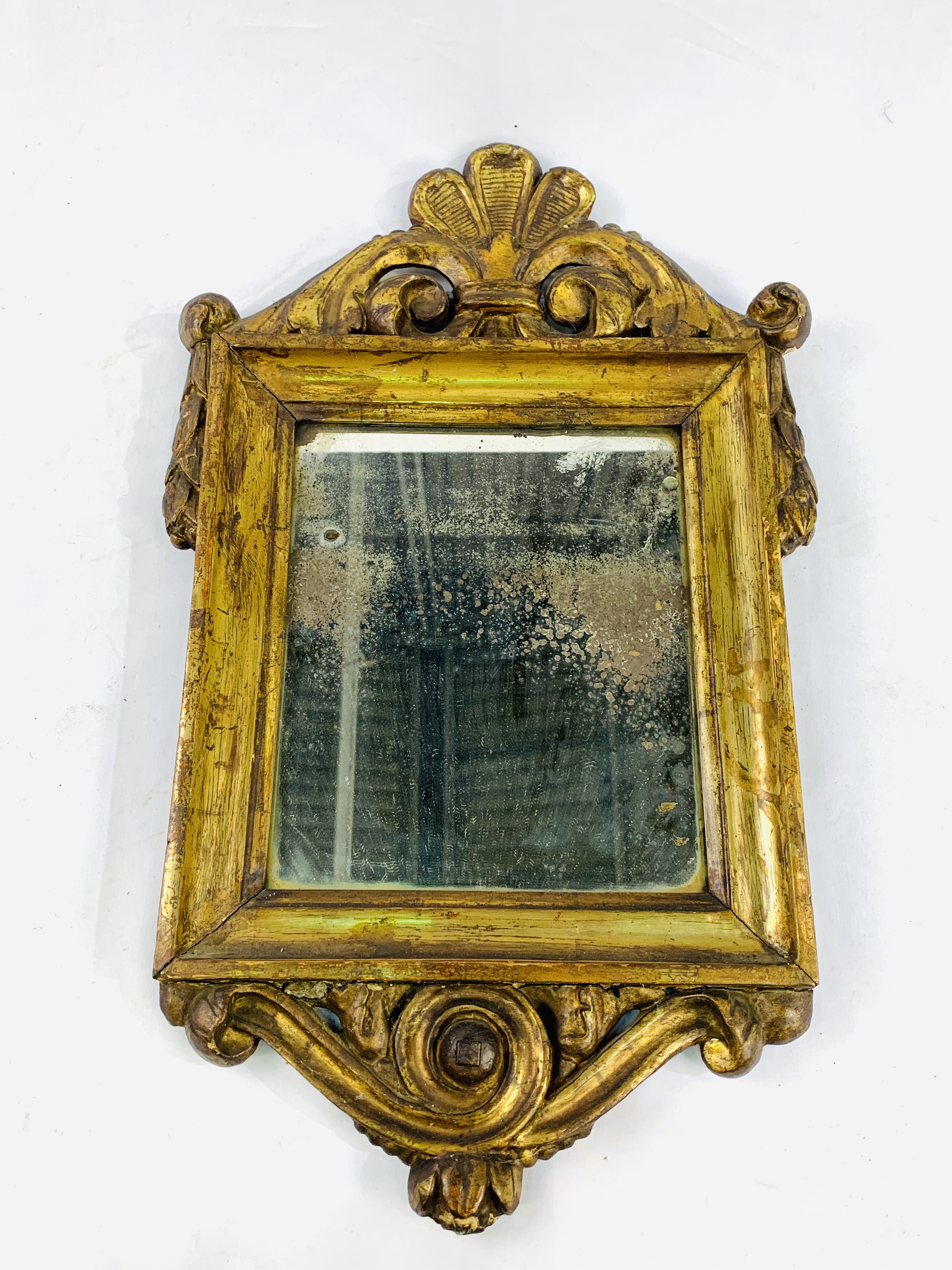 18th century gilt framed candle mirror with carved pediment
