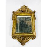 18th century gilt framed candle mirror with carved pediment