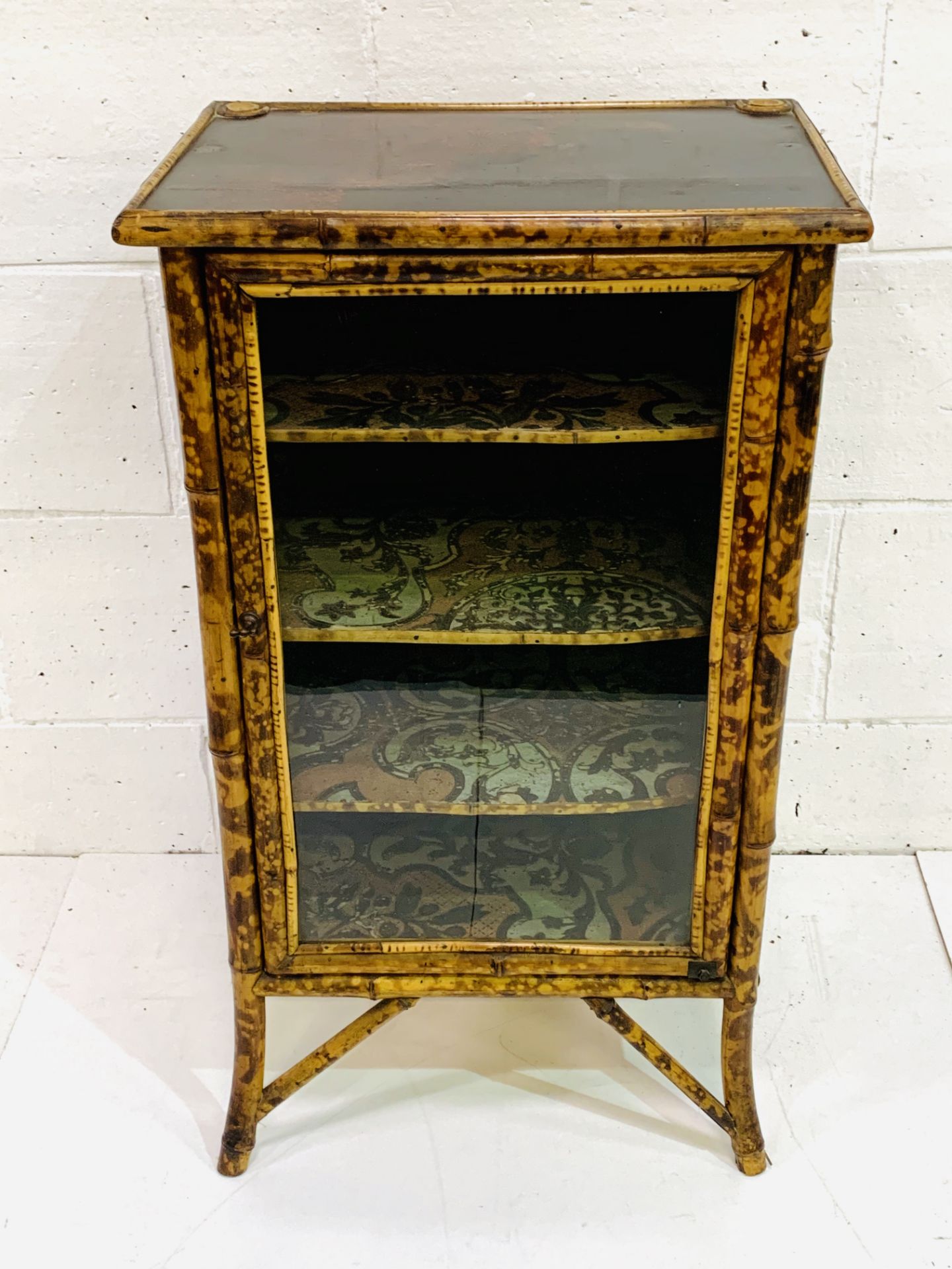 Bamboo glass fronted decorative display cabinet.