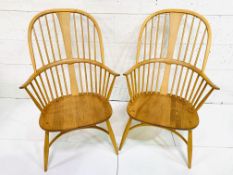 Two Ercol rail back elbow chairs.