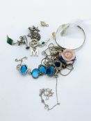 12 silver charms and a bag of silver jewellery