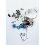 12 silver charms and a bag of silver jewellery