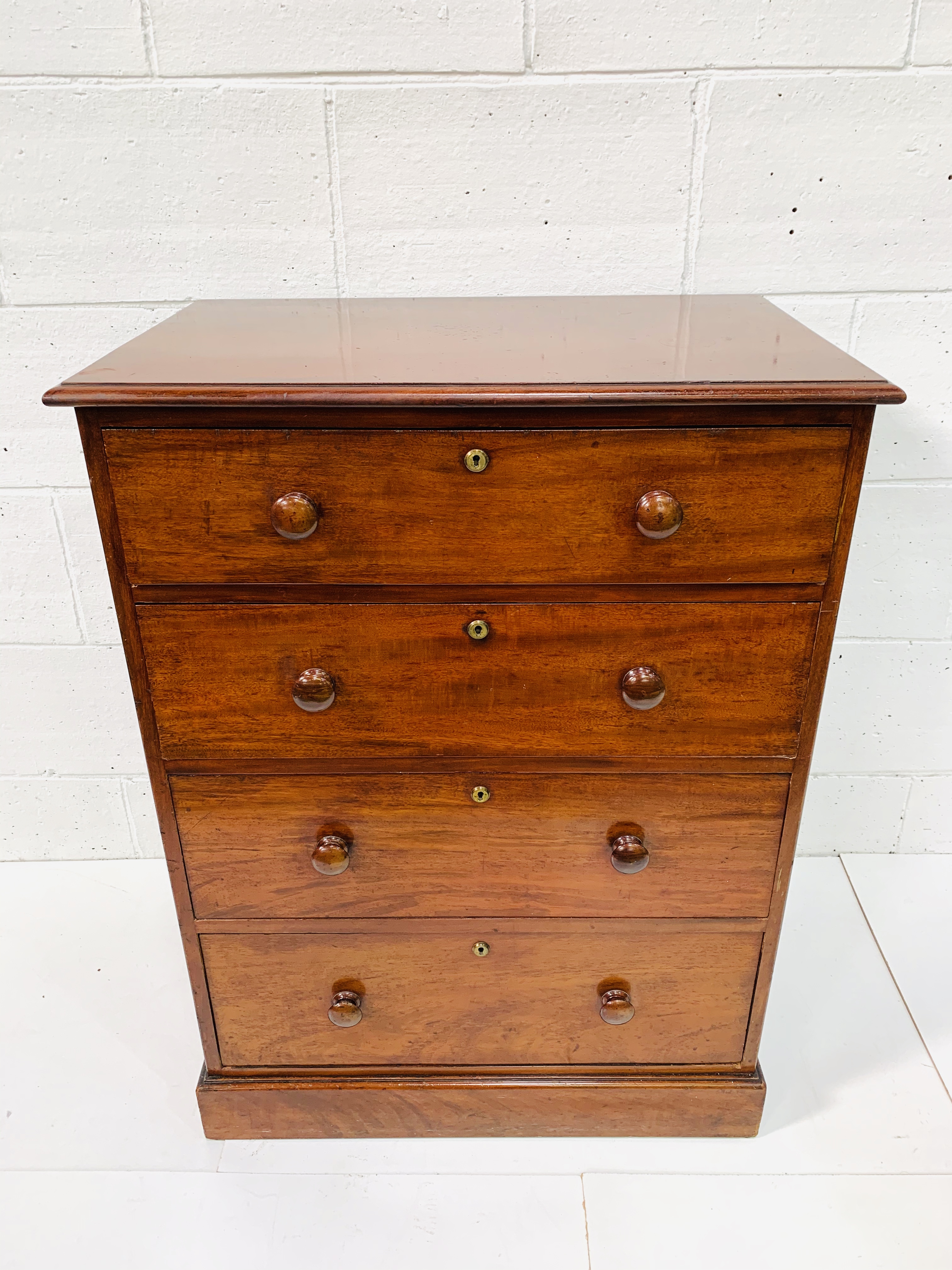 Mahogany chest of four graduated drawers by Spillman and Co.