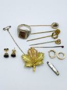 5 stick pins; 2 pairs of earrings; gold plated maple leaf brooch; a silver coloured ring; and a mini