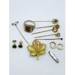 5 stick pins; 2 pairs of earrings; gold plated maple leaf brooch; a silver coloured ring; and a mini