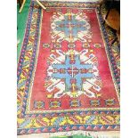 Red ground hand knotted Middle Eastern rug.