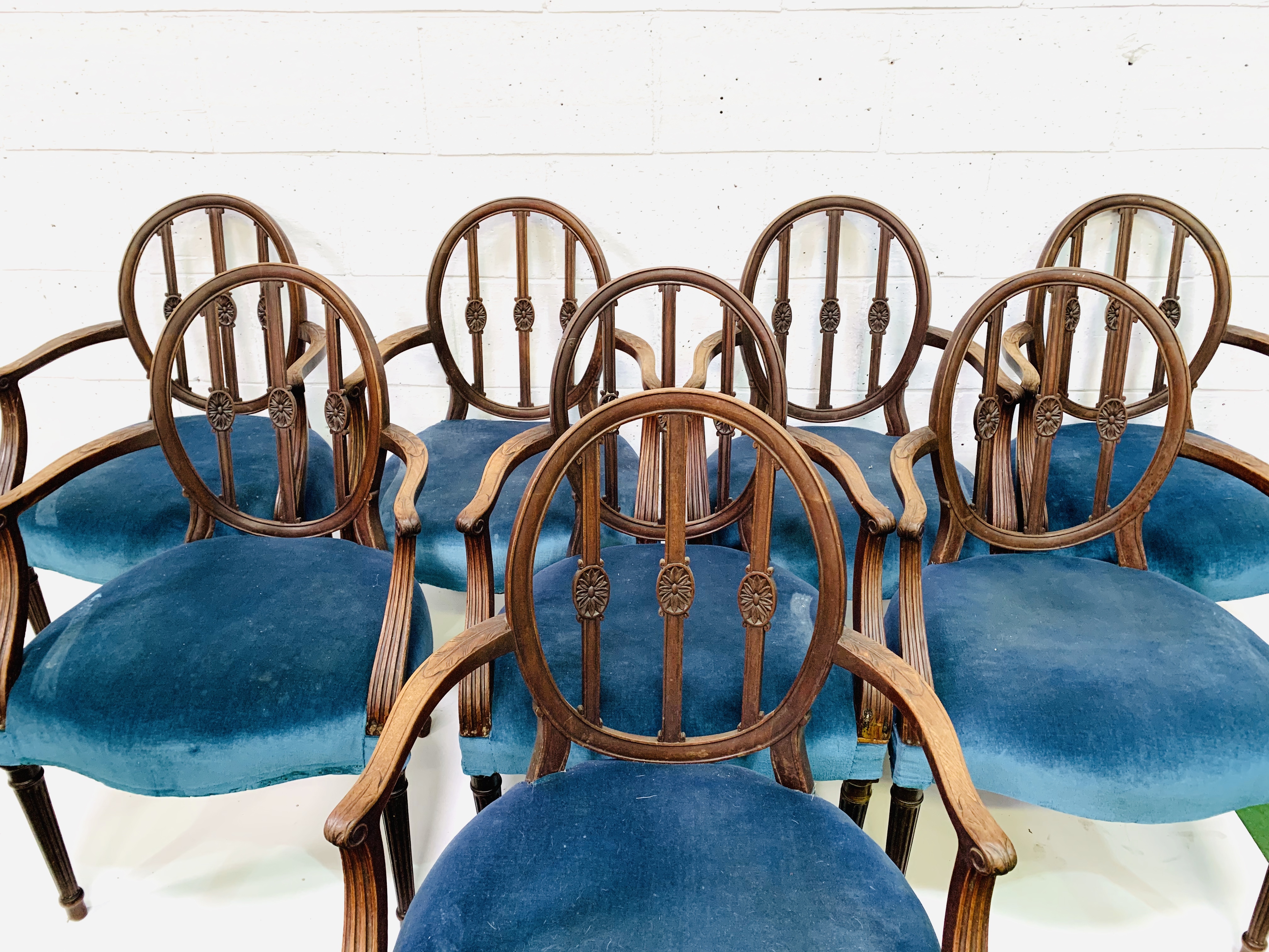 Set of eight mahogany Regency style open elbow chairs upholstered in petrol blue velvet.