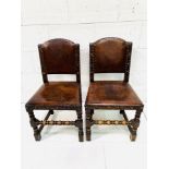 Two studded leather and oak hall chairs.