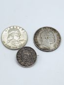 1818 George III half crown; a 1957 US half dollar; and a 1 lira silver coin dated 1886 made into a b