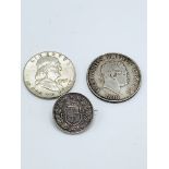 1818 George III half crown; a 1957 US half dollar; and a 1 lira silver coin dated 1886 made into a b