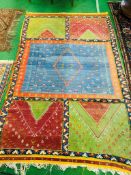 Hand knotted carpet with coloured panels.