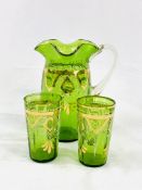 Victorian gilt decorated green glass jug and two beakers.