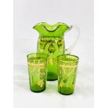 Victorian gilt decorated green glass jug and two beakers.