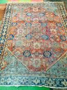 Red ground hand knotted rug.