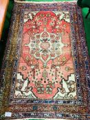 Pink ground hand knotted rug.