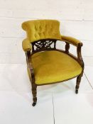 Mahogany yellow buttoned velvet upholstered open arm chair with decorative splat.