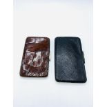 A crocodile skin wallet together with a black leather and hallmarked silver wallet