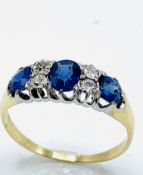 Gold sapphire and diamond trilogy ring. Size M Wt. 2.6g.