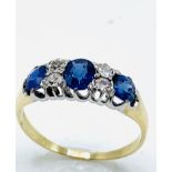 Gold sapphire and diamond trilogy ring. Size M Wt. 2.6g.