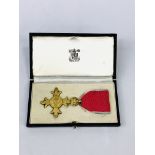 An Order of the British Empire Insignia in original box.
