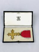 An Order of the British Empire Insignia in original box.