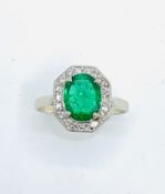 White gold diamond and emerald ring. Size K. Wt 2.1gms Centre emerald 6.2 x 8.00mm.