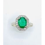 White gold diamond and emerald ring. Size K. Wt 2.1gms Centre emerald 6.2 x 8.00mm.