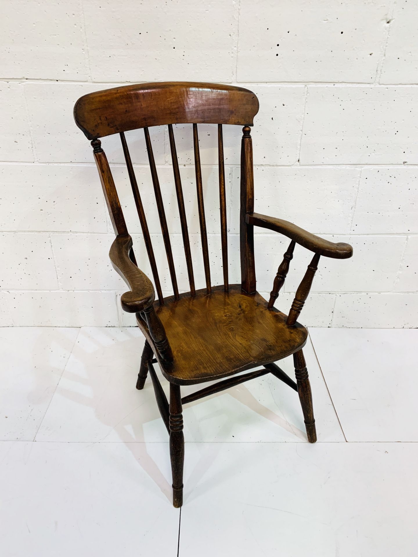 Elm seat high back farmhouse open armchair with spindle back.