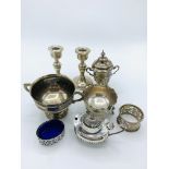 A pair of small silver candlesticks, 2 silver trophies, and silver cruets