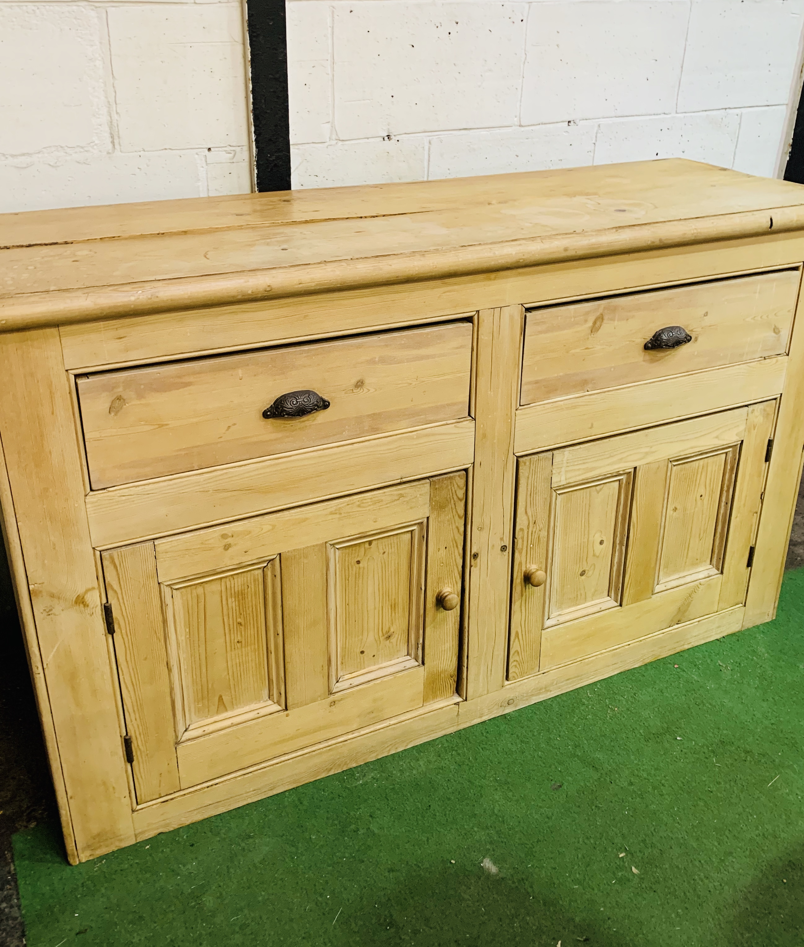 Antique pine sideboard with two drawers over two cupboards.