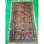 Red ground hand knotted Middle Eastern rug.
