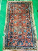 Red ground hand knotted Middle Eastern rug.