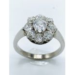 White gold diamond daisy ring. Size N. Wt 5.4gms centre stone diameter 5.7mm.