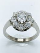 White gold diamond daisy ring. Size N. Wt 5.4gms centre stone diameter 5.7mm.