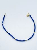 Yellow gold clasp and bead with blue rubber bracelet