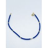 Yellow gold clasp and bead with blue rubber bracelet