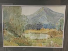 Framed and glazed watercolour of a lake and mountain scene by Eric Johnson, 1975.