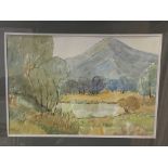 Framed and glazed watercolour of a lake and mountain scene by Eric Johnson, 1975.