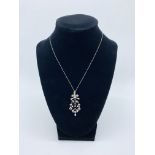 Diamond and pearl pendant on a platinum chain. Length of pendant 47.2 mms. Length of chain 40 cms