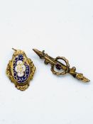 Victorian 9ct gold and ruby bar brooch, and a yellow metal and enamel pendant