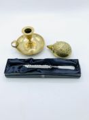 Brass hedgehog, brass candle holder and a boxed Douglas Pell mother of pearl handled paper knife
