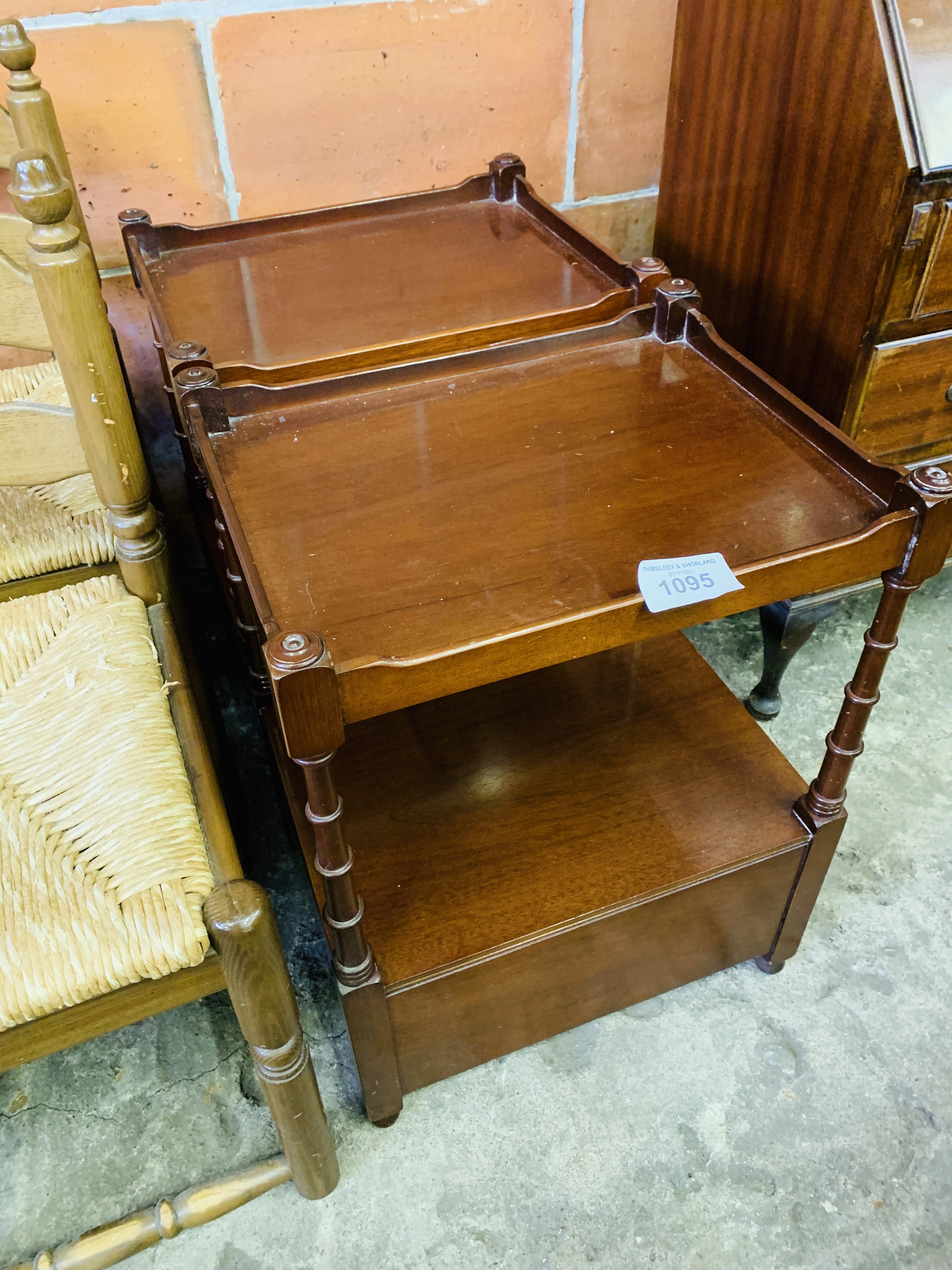 Pair of mahogany occasional tables with display shelf and two drawers below.