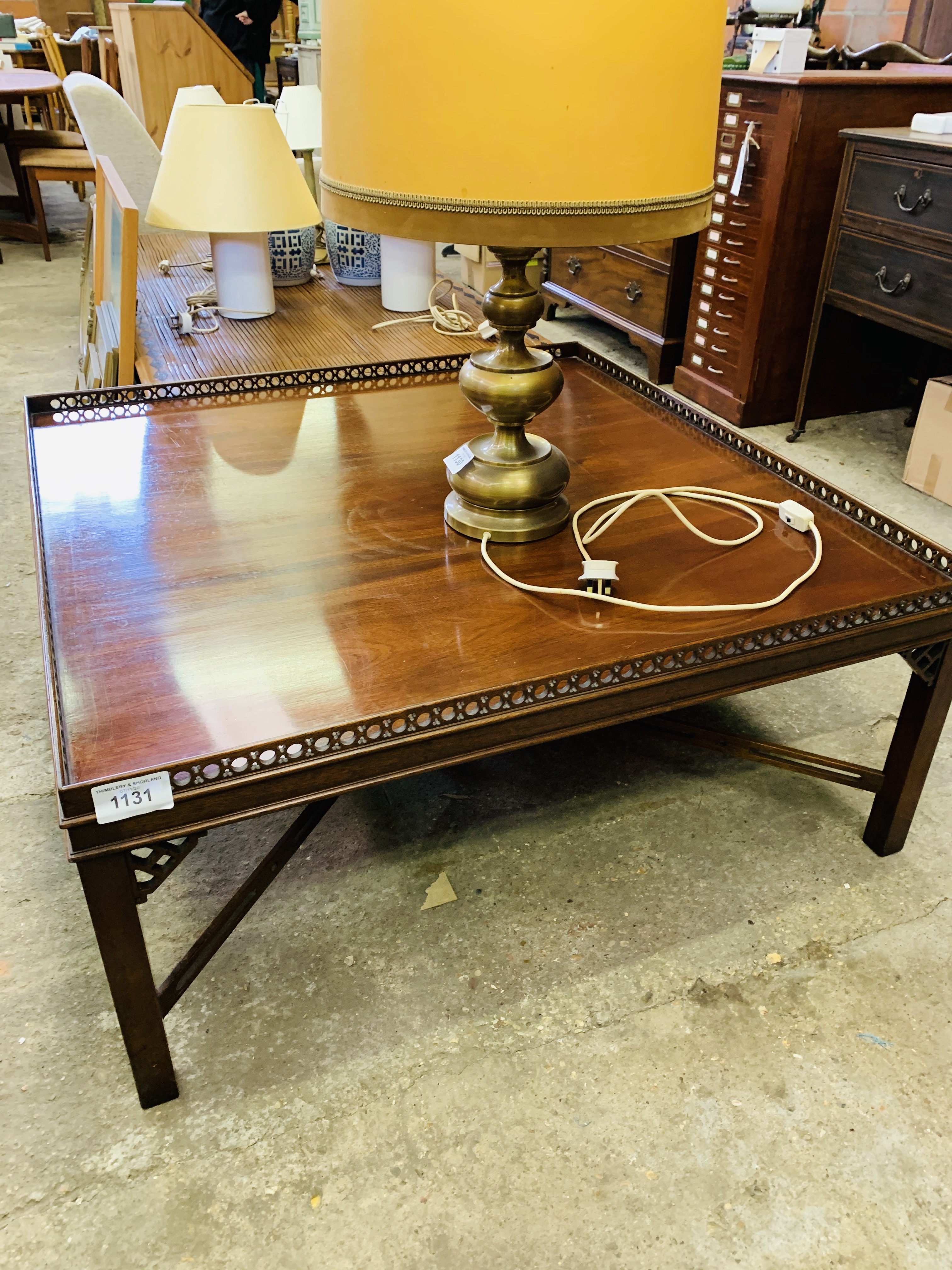 Large square mahogany coffee table with pierced upstand.
