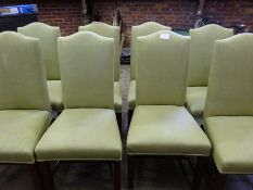 Eight high back dining chairs upholstered in pistachio coloured fabric.