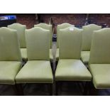 Eight high back dining chairs upholstered in pistachio coloured fabric.