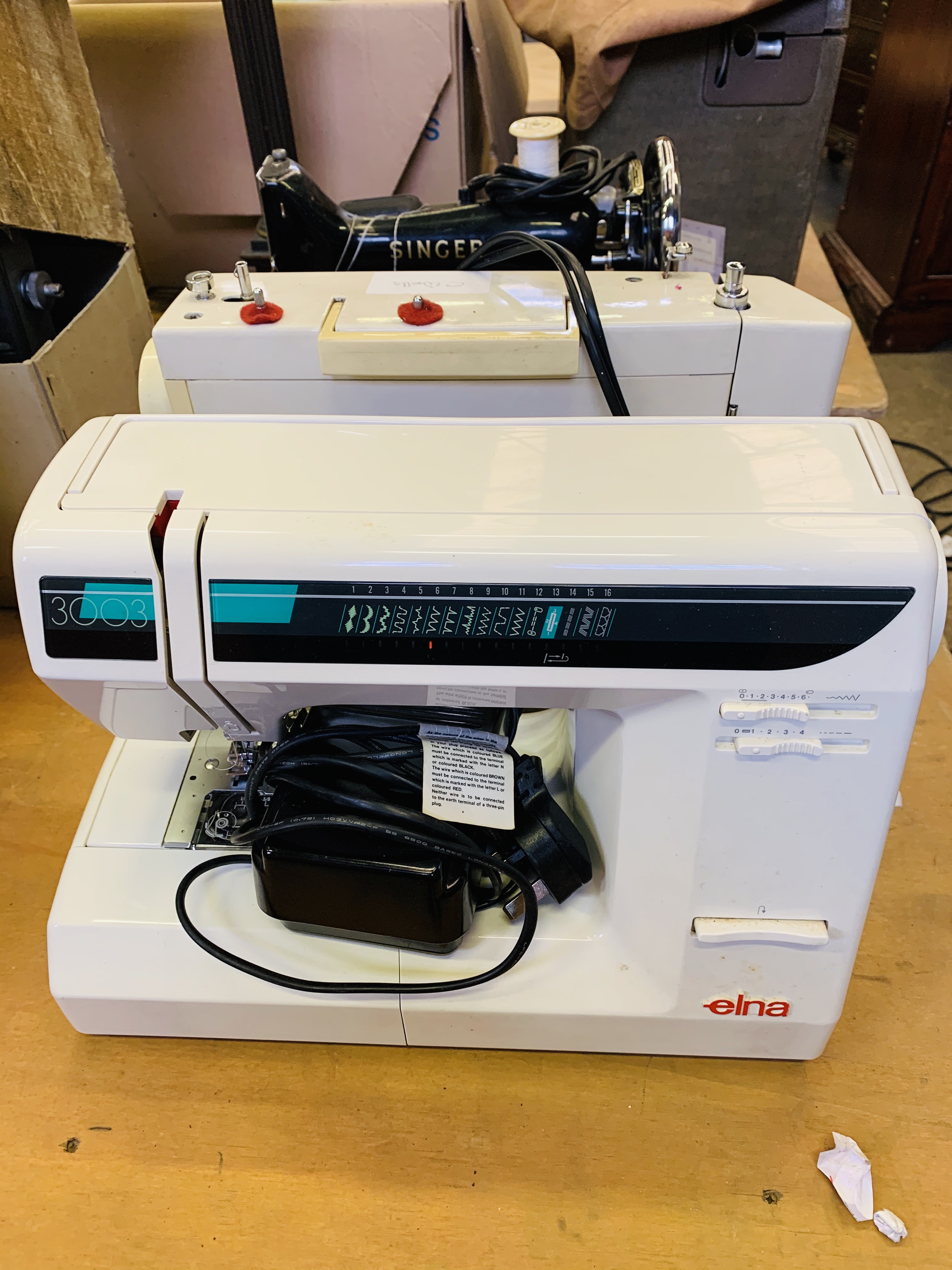 Elna 3003 electric sewing machine with one other machine.